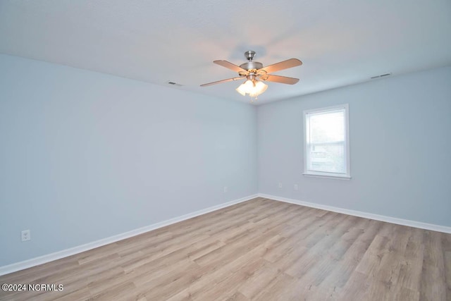 spare room featuring ceiling fan and light hardwood / wood-style flooring