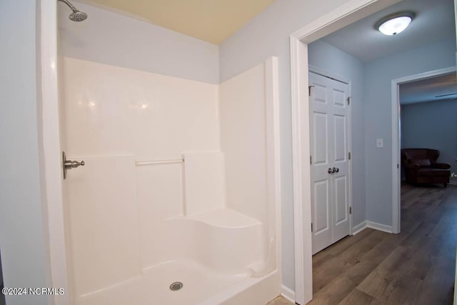 bathroom featuring wood-type flooring and walk in shower