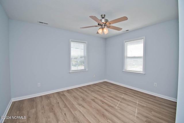 empty room featuring ceiling fan and light hardwood / wood-style floors