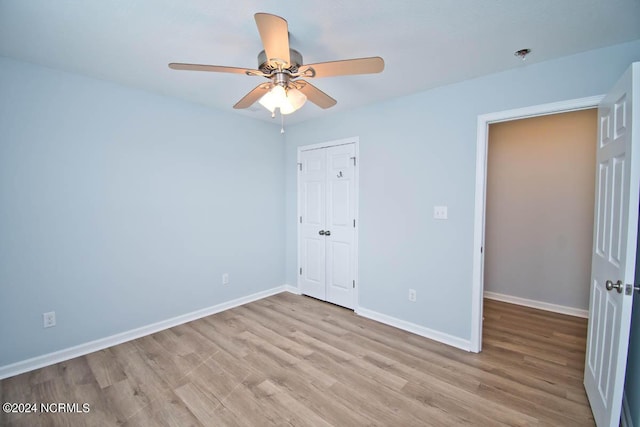 unfurnished bedroom with ceiling fan, light hardwood / wood-style floors, and a closet