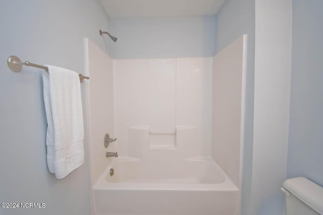 bathroom with shower / washtub combination and toilet