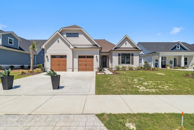 5037 Saltgrass Cv, Leland, NC 28451 - view of front of property with driveway, a front lawn, a garage, a standing seam roof, and metal roof