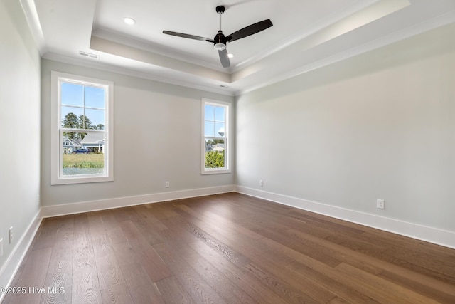 5037 Saltgrass Cv, Leland, NC 28451 - spare room featuring crown molding, a raised ceiling, dark wood finished floors, a ceiling fan, and baseboards