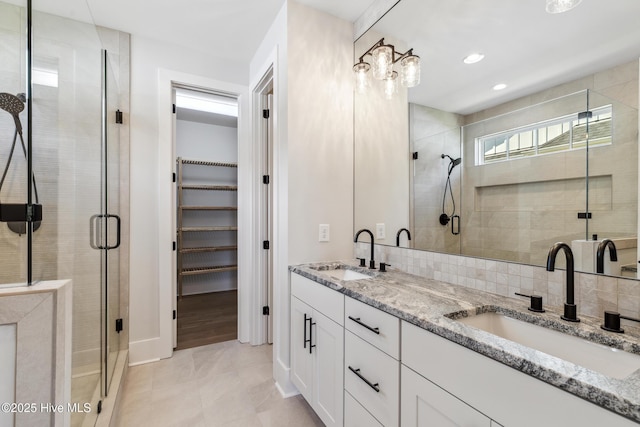 5037 Saltgrass Cv, Leland, NC 28451 - full bathroom with a shower stall, a walk in closet, double vanity, baseboards, and recessed lighting