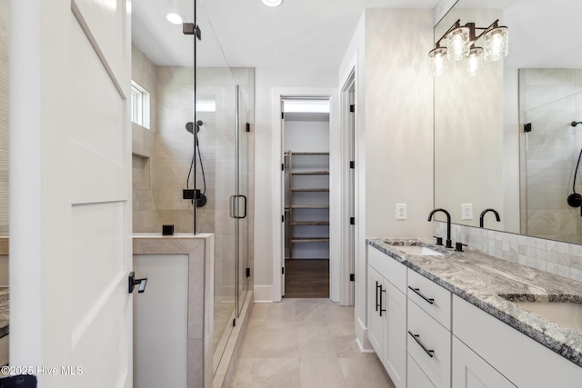 5037 Saltgrass Cv, Leland, NC 28451 - full bath featuring a stall shower, a walk in closet, double vanity, and tile patterned floors