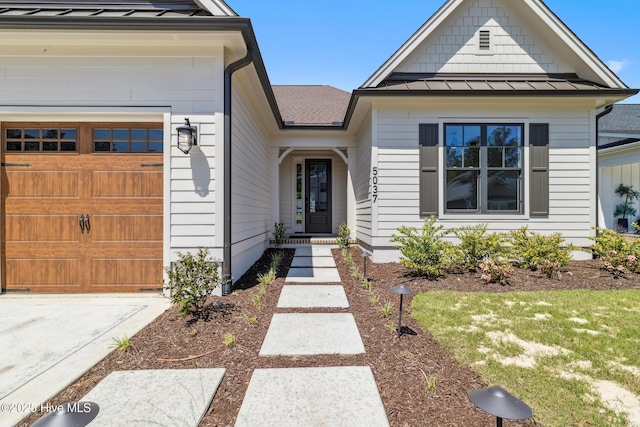 5037 Saltgrass Cv, Leland, NC 28451 - view of front of property with a standing seam roof, metal roof, a garage, a shingled roof, and concrete driveway