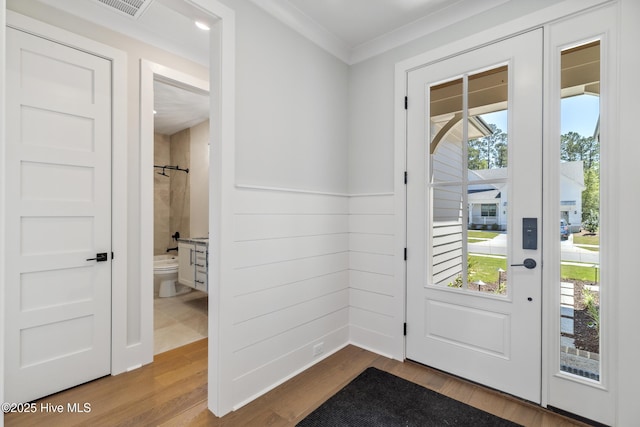 5037 Saltgrass Cv, Leland, NC 28451 - entryway with plenty of natural light, wood finished floors, and crown molding