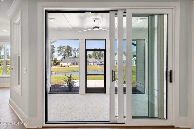 5037 Saltgrass Cv, Leland, NC 28451 - doorway with baseboards, a water view, and wood finished floors