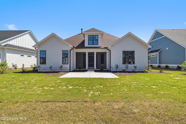 5037 Saltgrass Cv, Leland, NC 28451 - rear view of house with a patio, a lawn, and roof with shingles