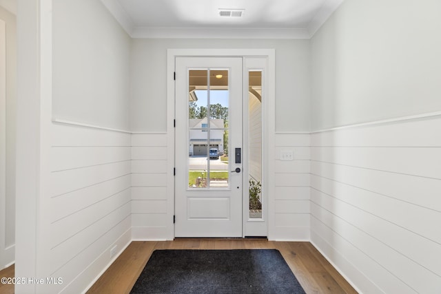 5037 Saltgrass Cv, Leland, NC 28451 - entryway with wood finished floors, wood walls, crown molding, and wainscoting