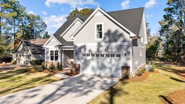 view of front of property featuring a front lawn and a garage