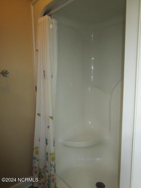 bathroom with a shower with shower curtain