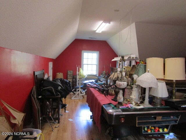 interior space featuring vaulted ceiling and wood finished floors