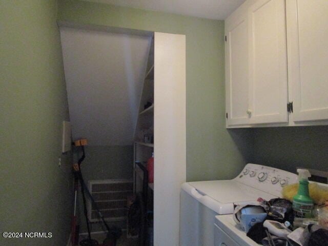 clothes washing area with cabinet space and washing machine and clothes dryer