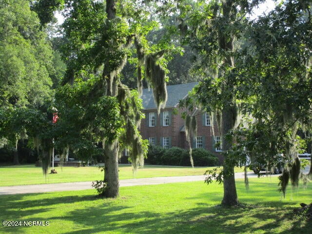 view of property's community with a lawn