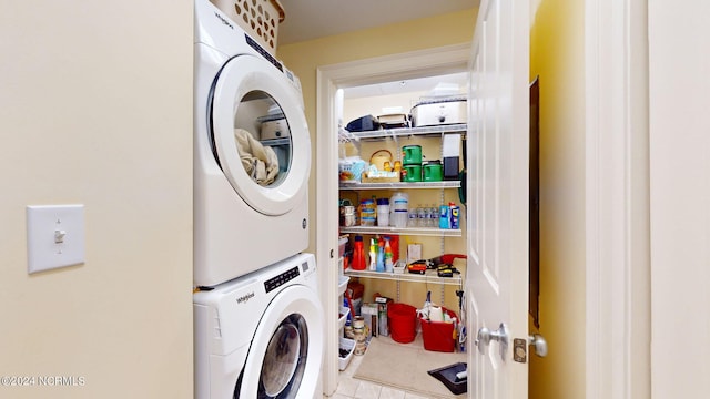 washroom with light tile patterned floors and stacked washer and clothes dryer