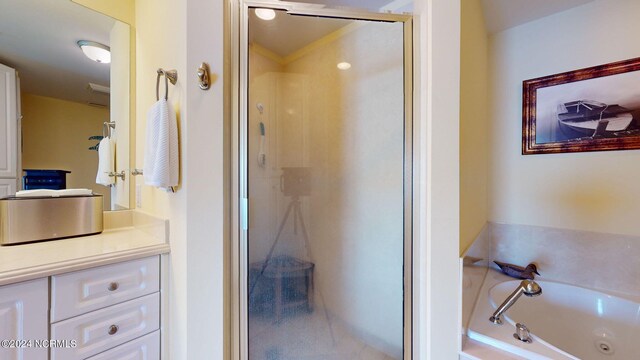 bathroom featuring plus walk in shower and vanity