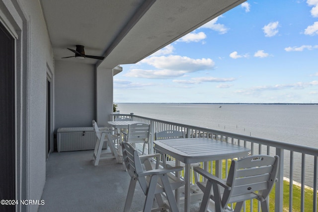 balcony featuring ceiling fan and a water view