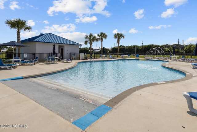 view of swimming pool featuring a patio area