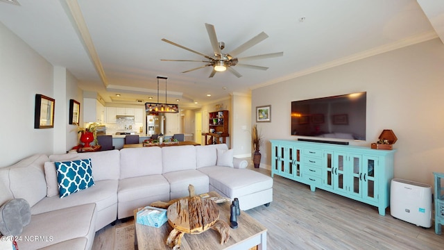 living room with ceiling fan, light wood-type flooring, and crown molding