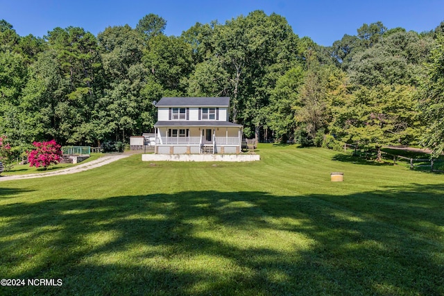 exterior space with covered porch and a front yard