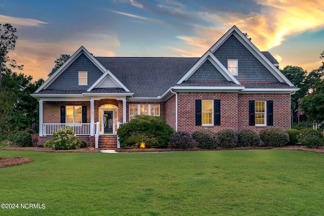 craftsman-style home featuring a yard and a porch