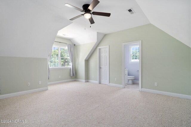 bonus room featuring light carpet, vaulted ceiling, visible vents, and baseboards