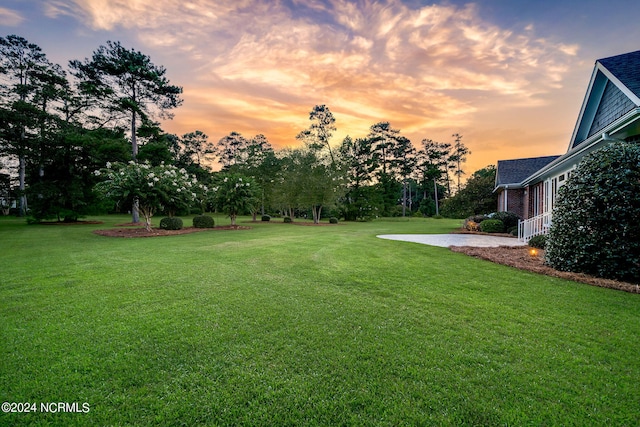 yard at dusk with a patio area