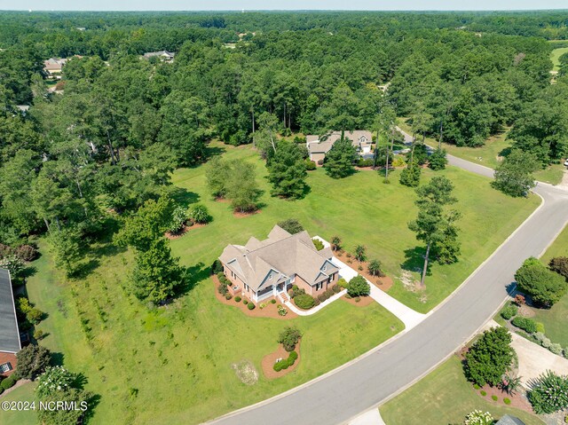 bird's eye view with a wooded view