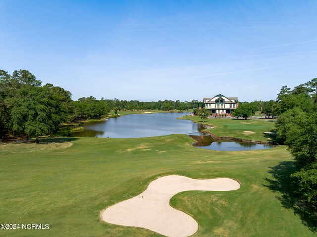 view of property's community featuring a water view, golf course view, and a lawn