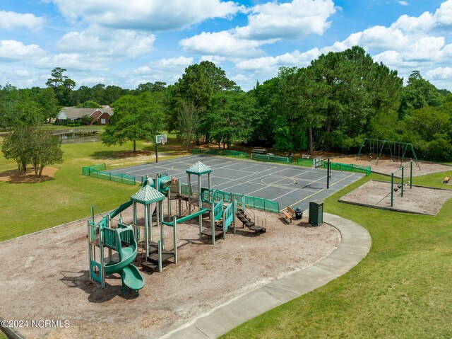 view of property's community with playground community and a yard