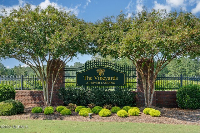 community sign featuring fence