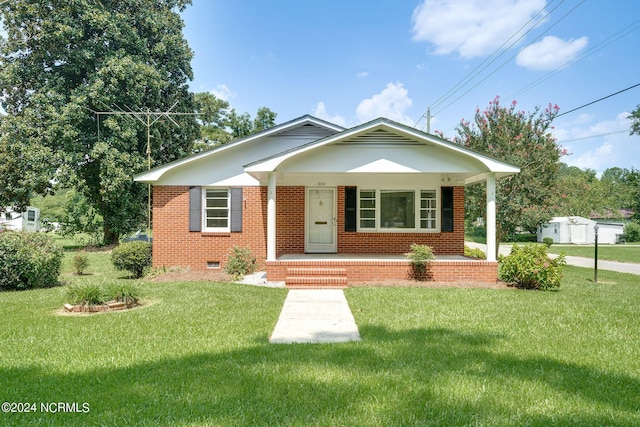 bungalow with a porch, brick siding, crawl space, and a front yard