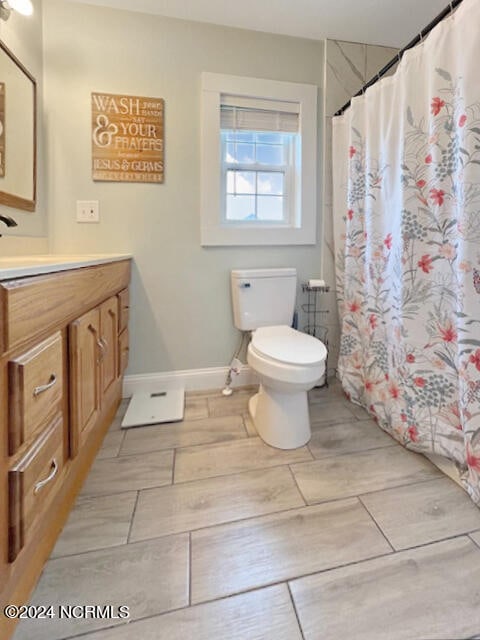 bathroom featuring vanity, toilet, hardwood / wood-style flooring, and a shower with shower curtain