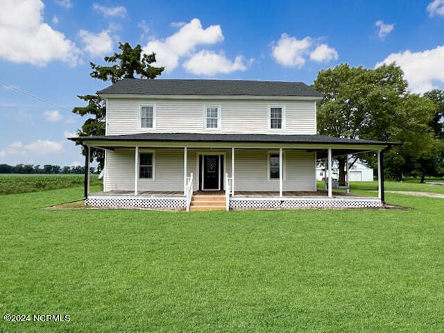 farmhouse with a porch and a front lawn