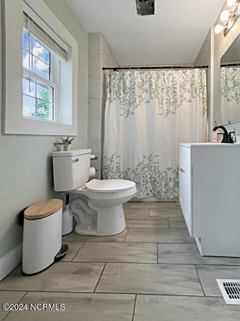 bathroom with vanity, toilet, and walk in shower