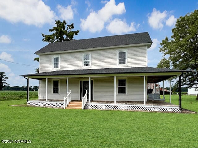 farmhouse-style home with a front yard and a porch