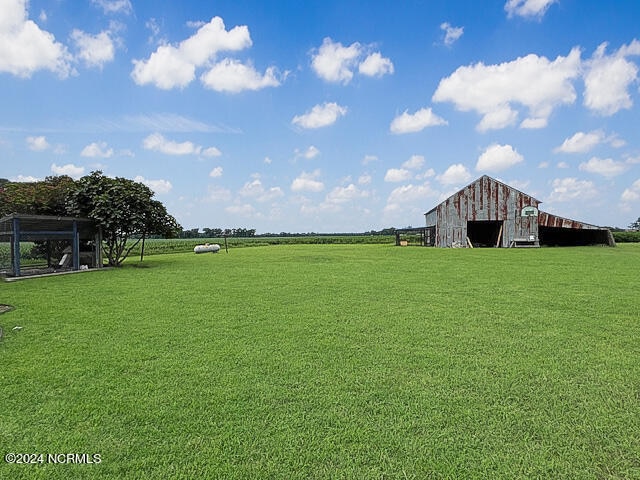 view of yard featuring an outdoor structure and a rural view