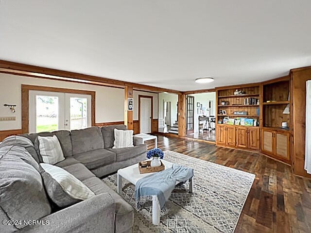 living room with french doors, ornamental molding, and dark hardwood / wood-style flooring