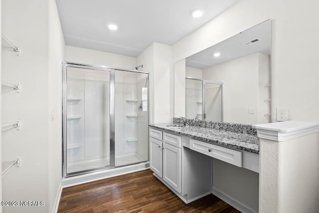 bathroom featuring recessed lighting, visible vents, a stall shower, vanity, and wood finished floors