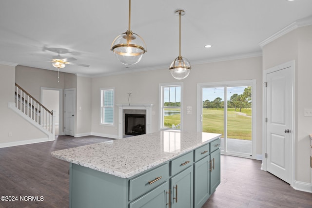 kitchen with a kitchen island, plenty of natural light, dark hardwood / wood-style floors, and a fireplace