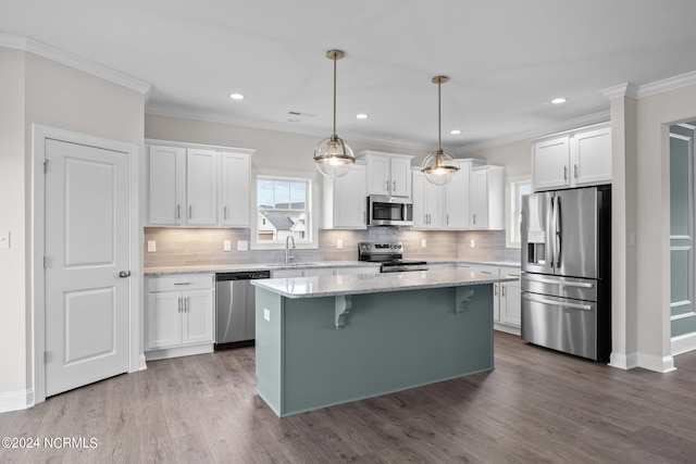 kitchen featuring a kitchen island, stainless steel appliances, decorative backsplash, and dark hardwood / wood-style flooring