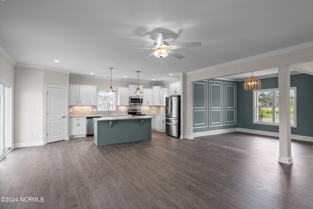 kitchen featuring appliances with stainless steel finishes, dark hardwood / wood-style flooring, decorative backsplash, and a kitchen island