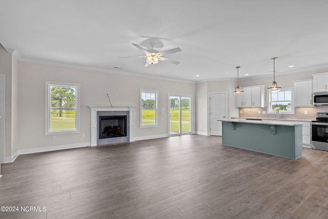 interior space featuring a kitchen island, stainless steel appliances, and hardwood / wood-style floors