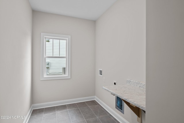 clothes washing area featuring tile patterned flooring, hookup for a washing machine, and hookup for an electric dryer