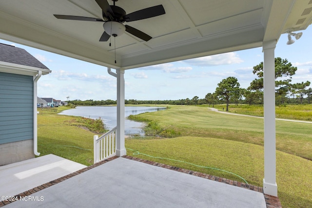 view of patio featuring ceiling fan and a water view