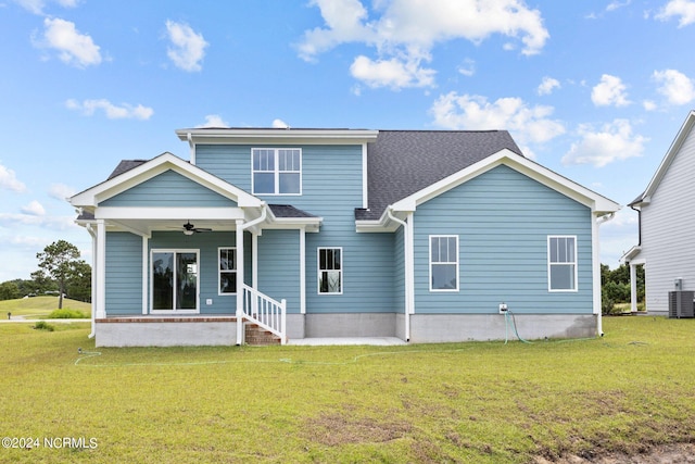 view of front facade with ceiling fan, a front lawn, and central AC