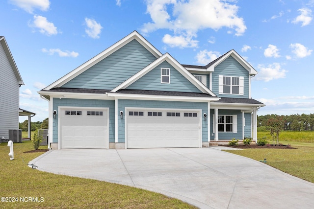 view of front facade featuring a garage, a front lawn, and cooling unit