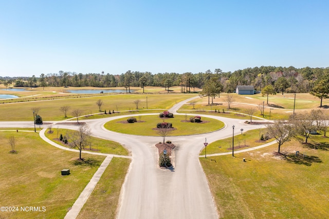 view of community with a yard and a water view