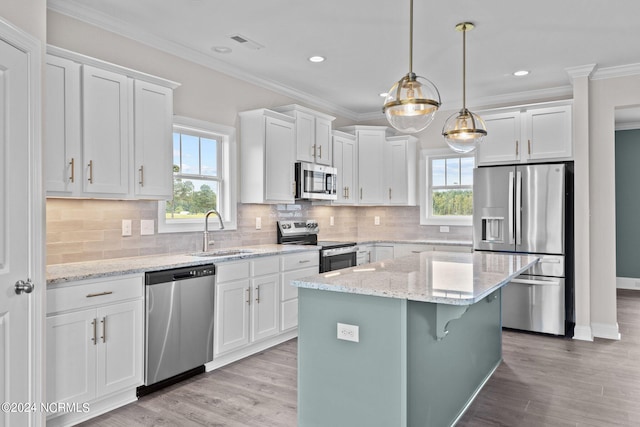 kitchen featuring sink, stainless steel appliances, decorative backsplash, and white cabinetry